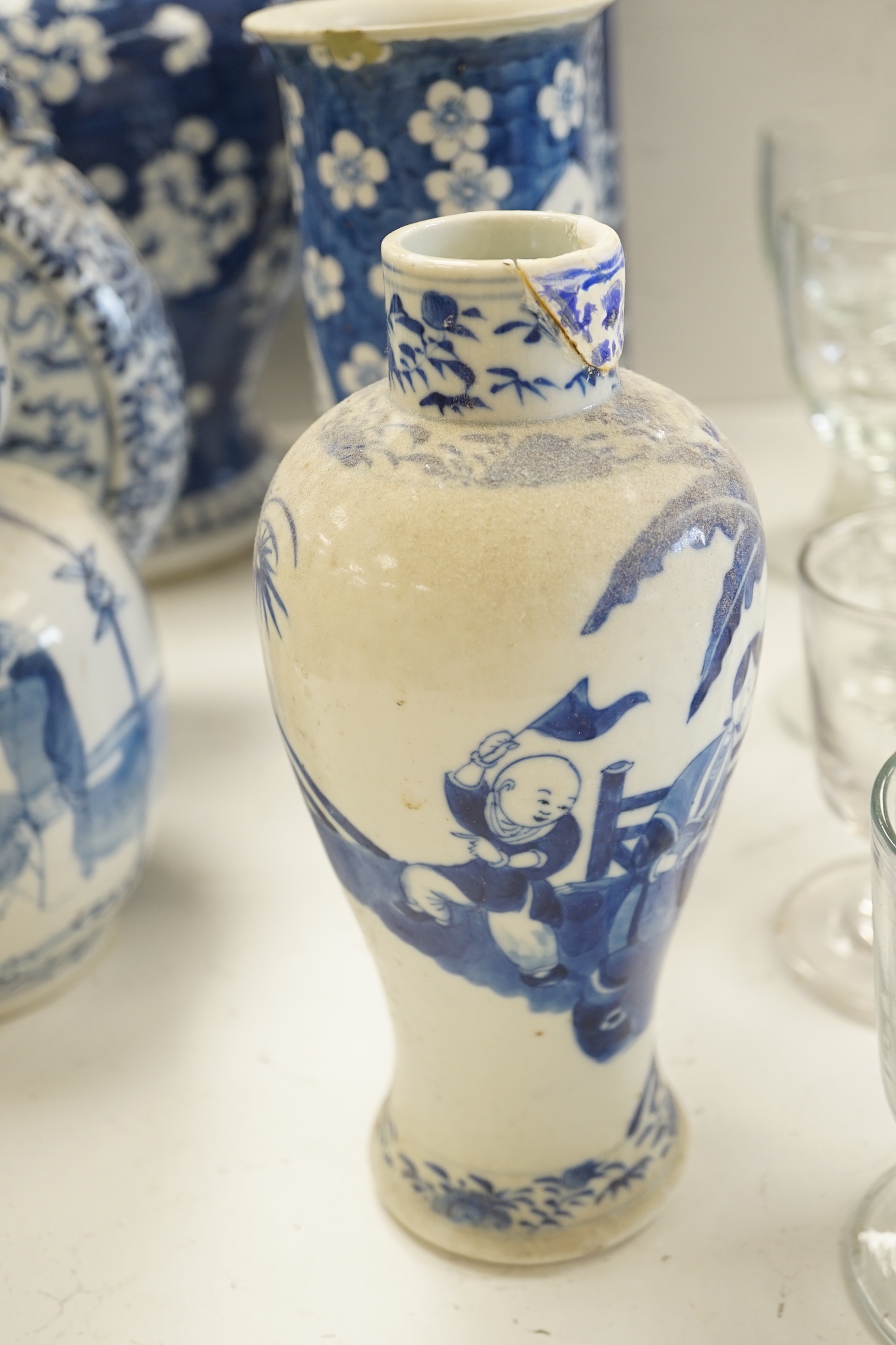 A Chinese blue and white Buddhist lion moon flask, a baluster vase, three sleeve vases and two others, 19th century, tallest 33cms (a.f.)